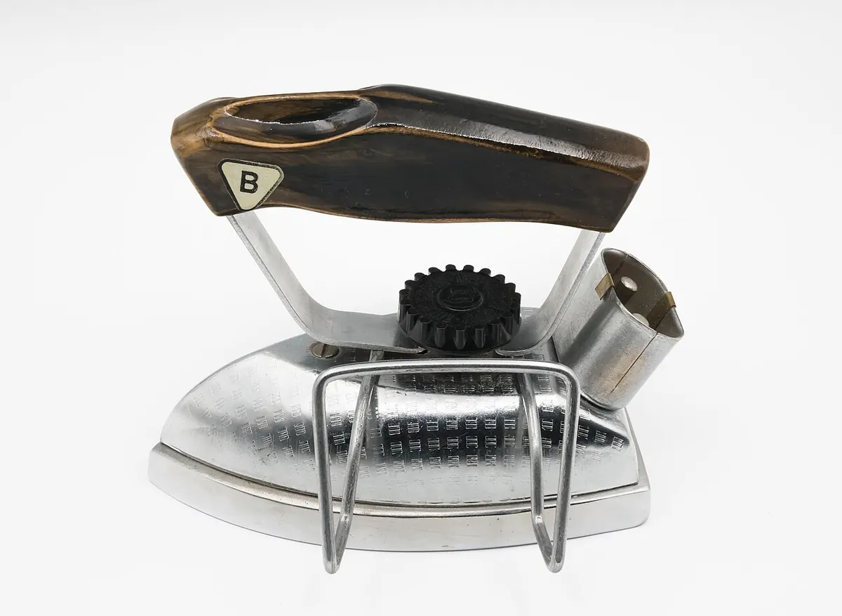 Compact electric travel iron on a white background