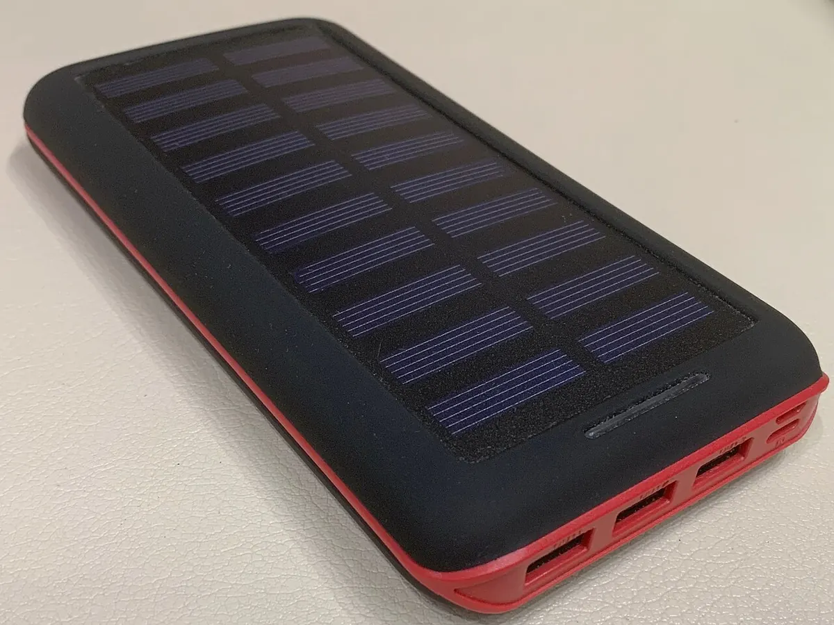 Black solar power bank with USB ports on a table