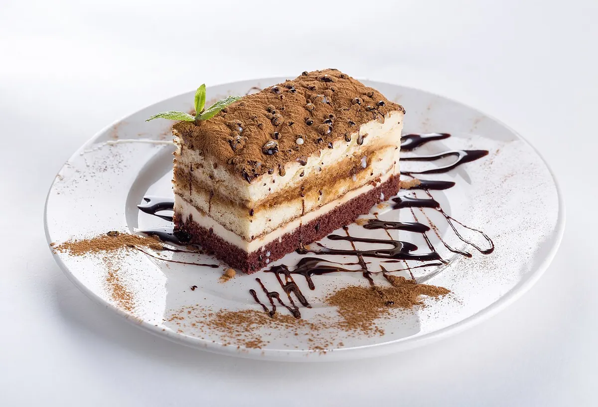 Slice of chocolate layer cake on a white plate
