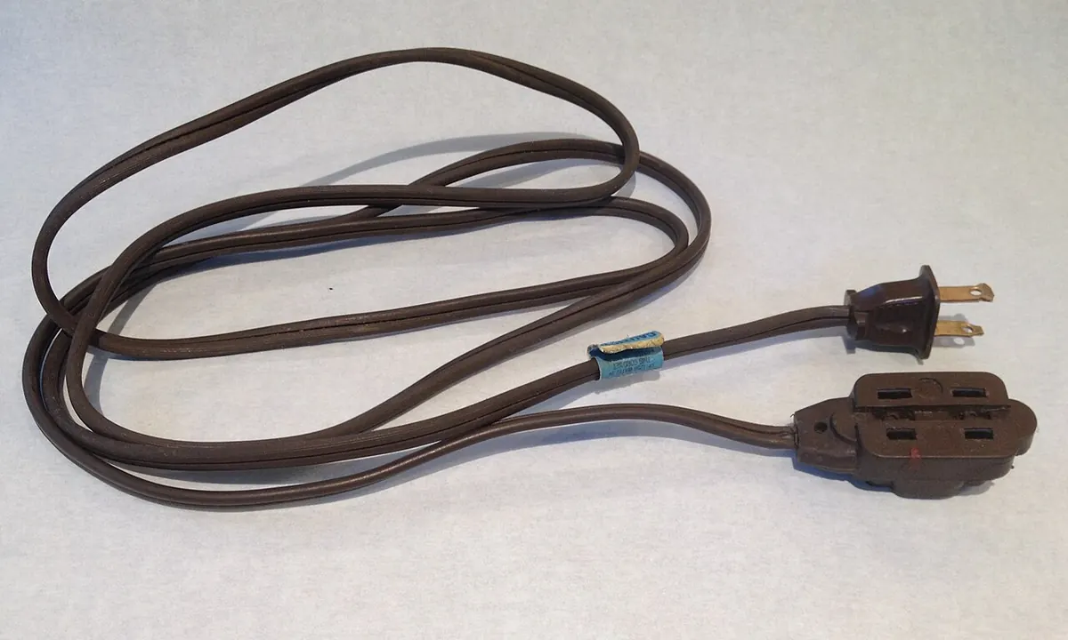 Brown household extension cord with a plug and socket block