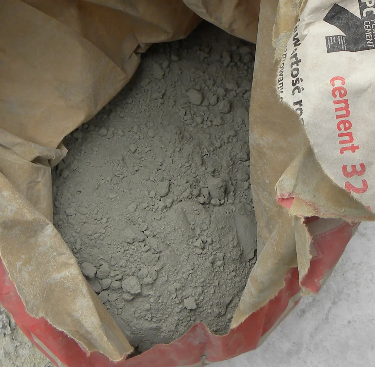 Open paper sack of grey cement powder