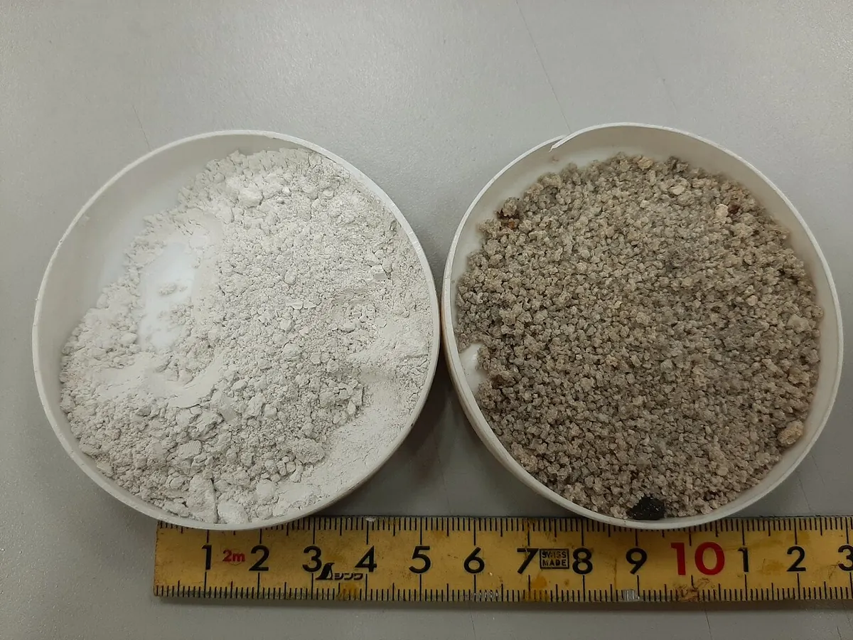 Bowls of ground and granulated blast furnace slag beside a ruler