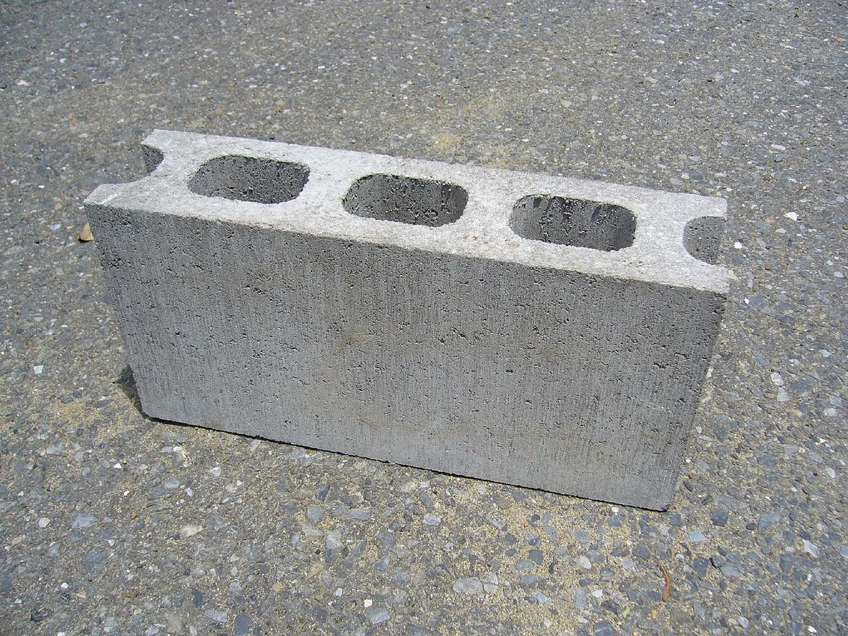 Single grey hollow concrete block on the ground