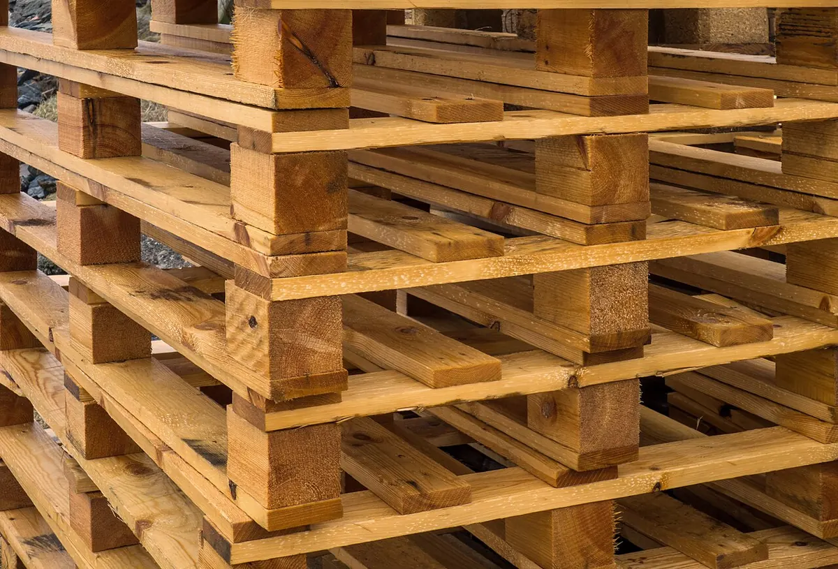 Stacked wooden pallets in an industrial yard