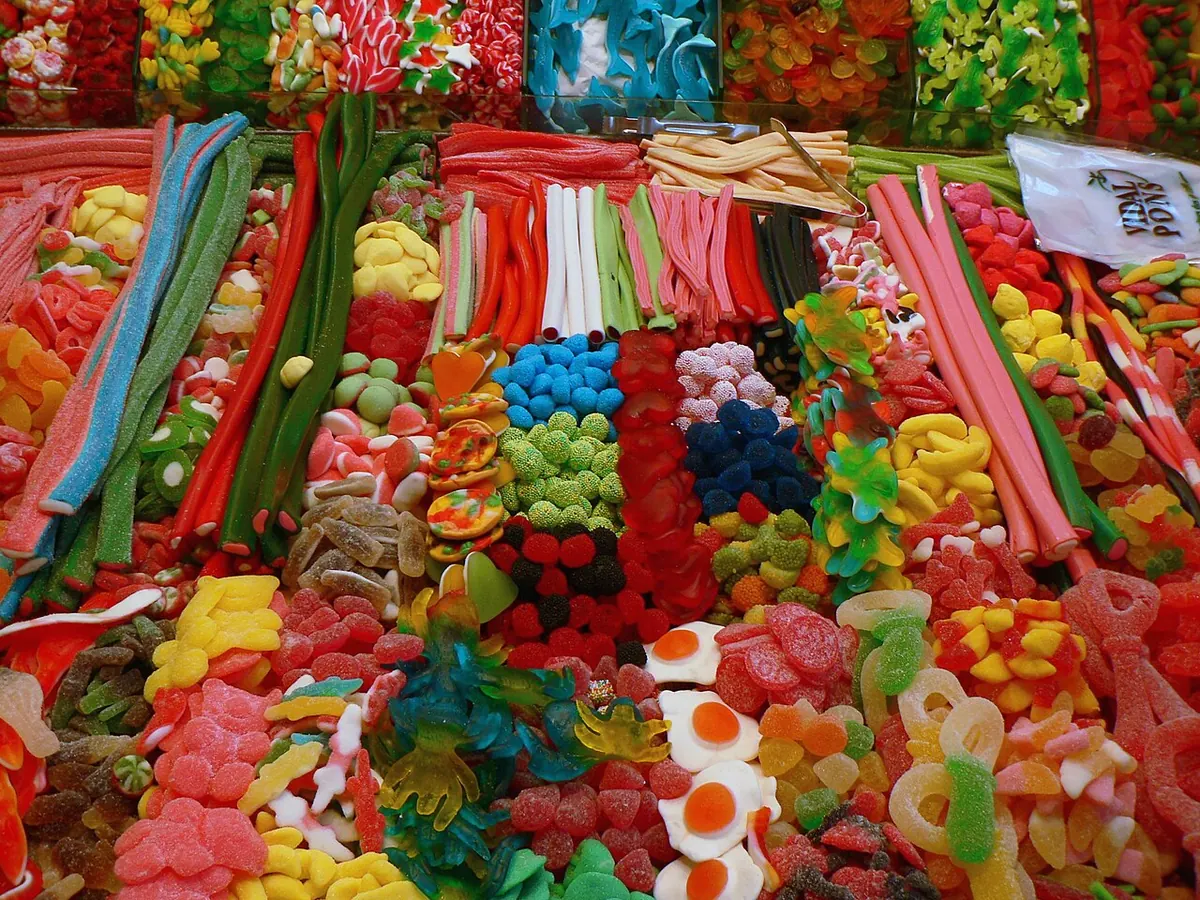 Market display of colourful jelly sweets and sour strips