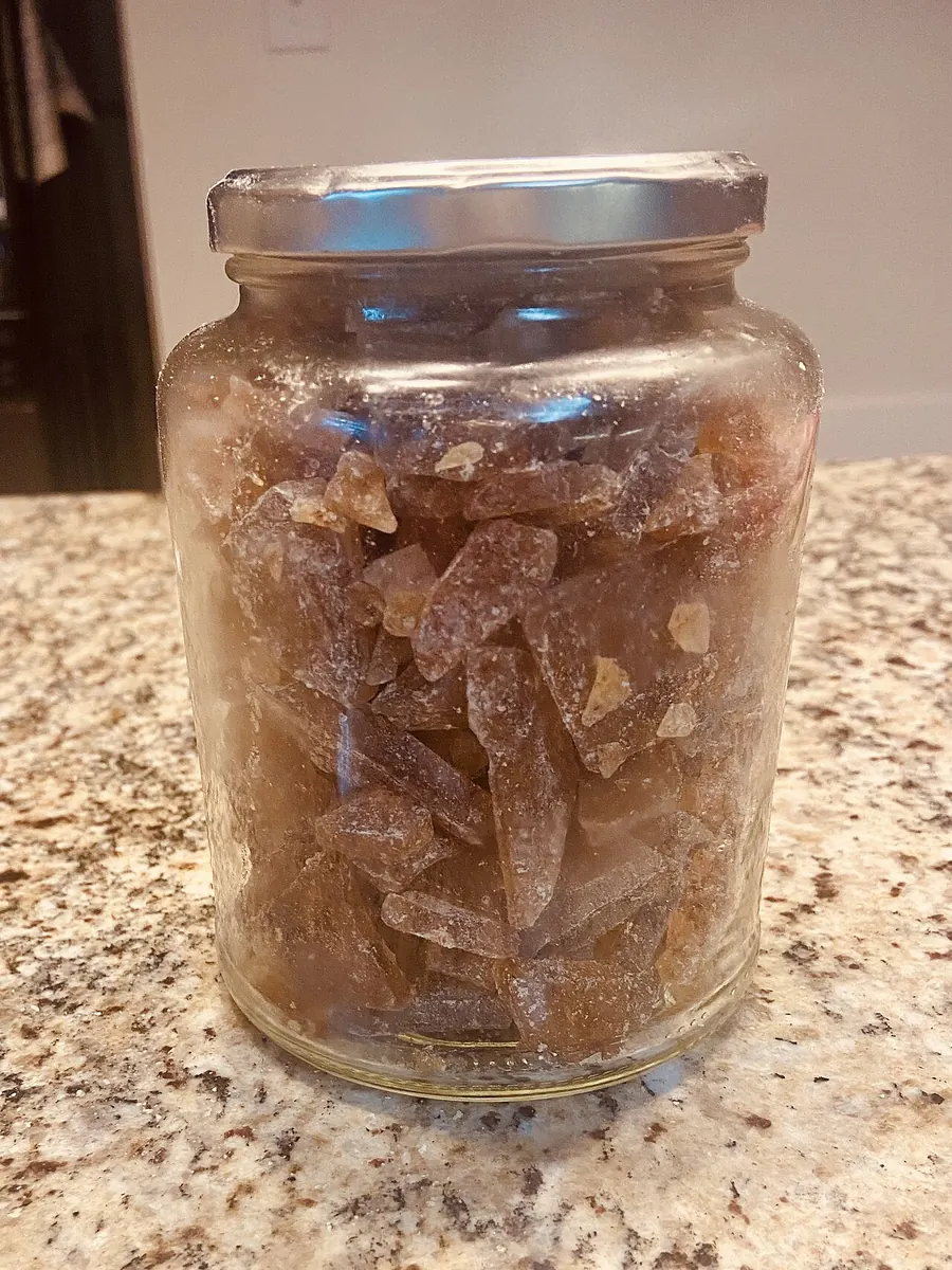 Glass jar of amber hard candy pieces