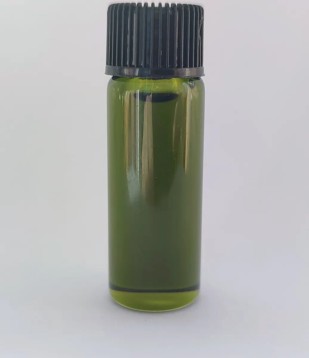 Small glass vial of green essential oil with a black cap