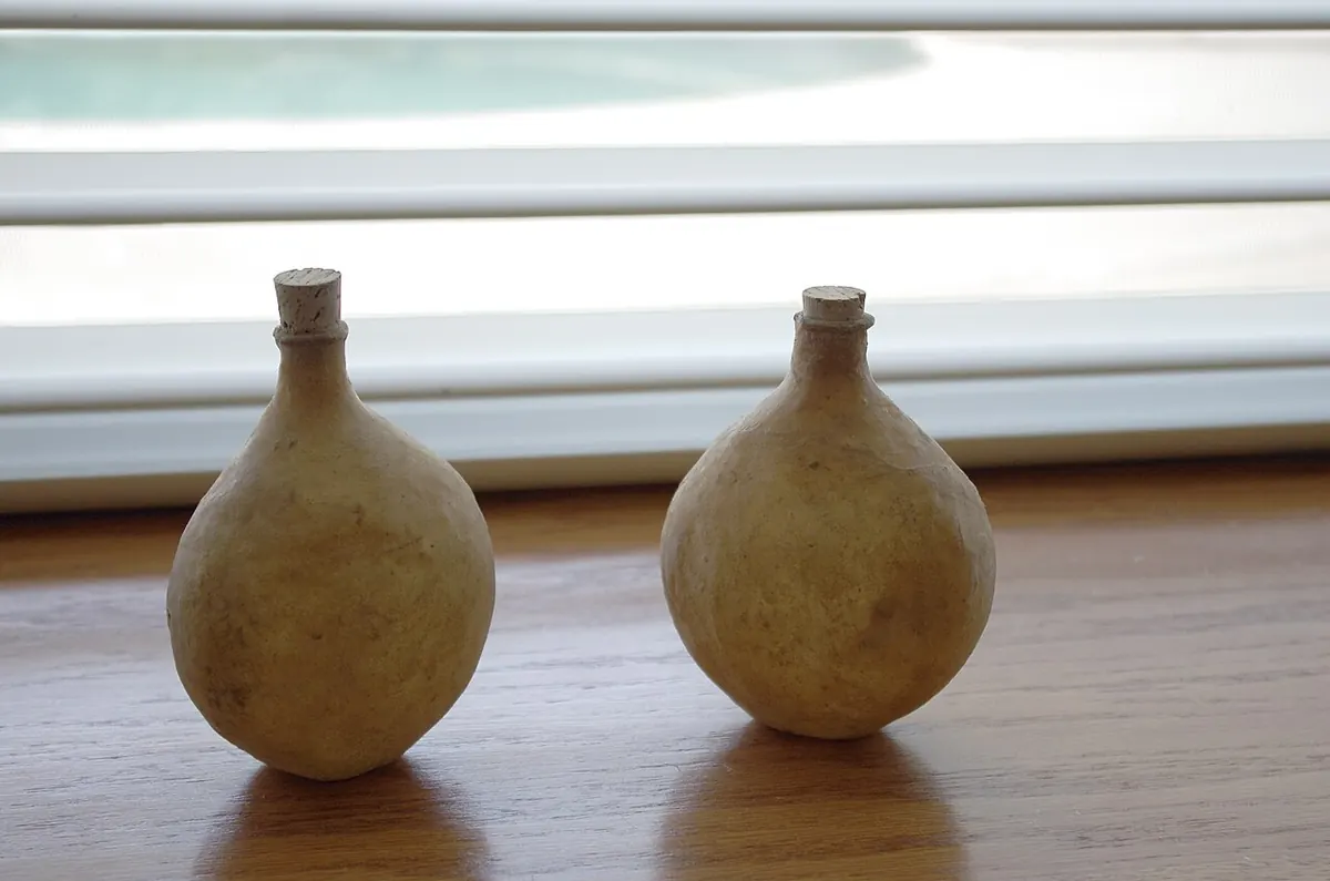 Two camel skin perfume flasks on a windowsill