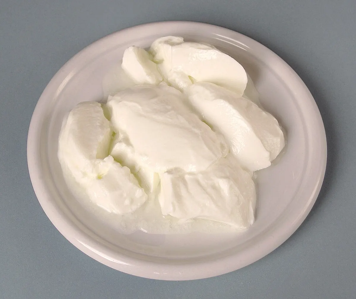 Thick plain yogurt on a white plate