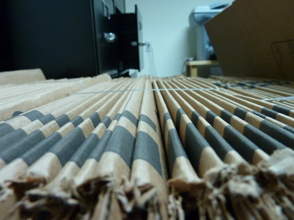 Stacked flat cardboard boxes seen edge on