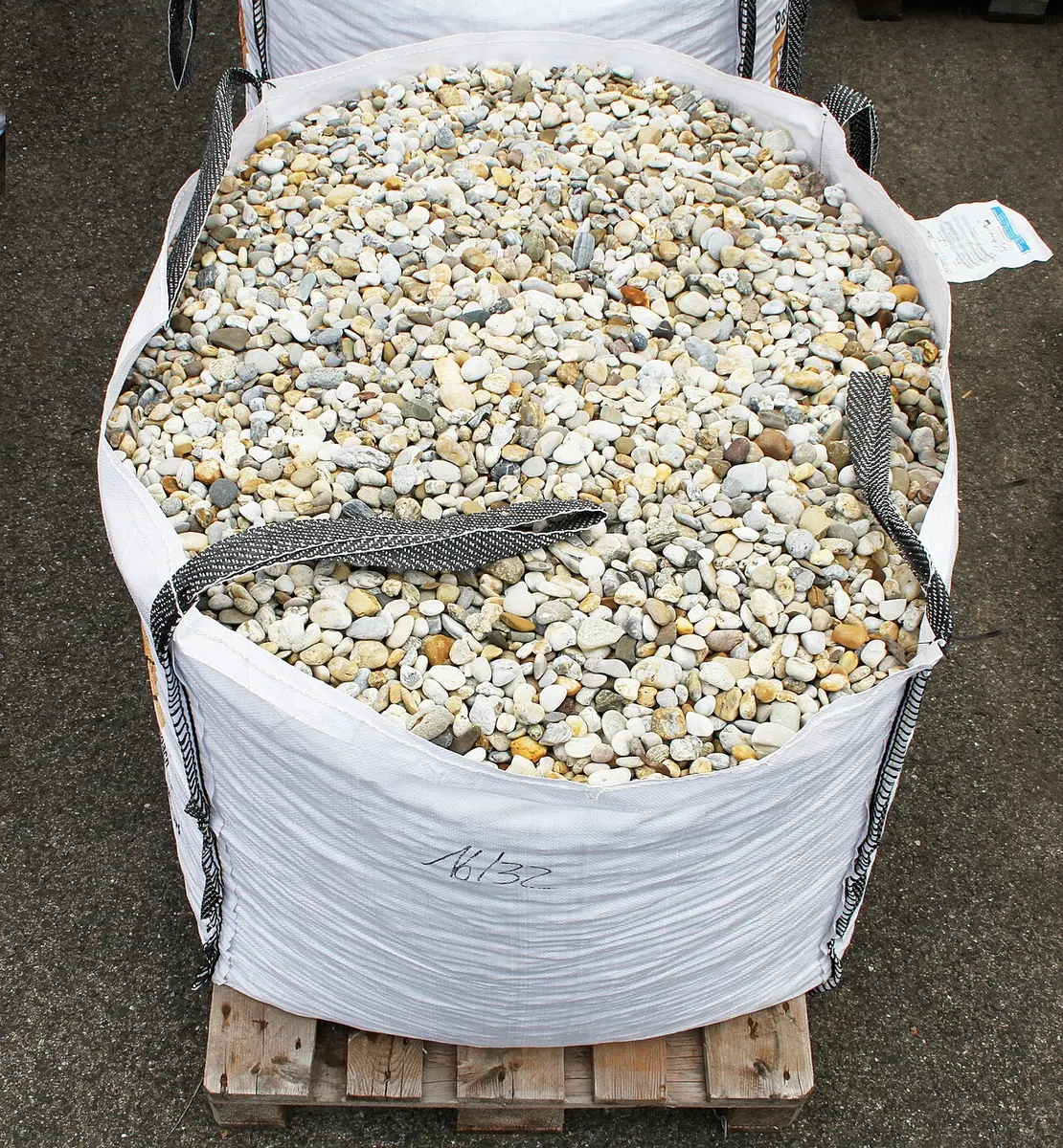 Woven jumbo bag filled with gravel on a wooden pallet
