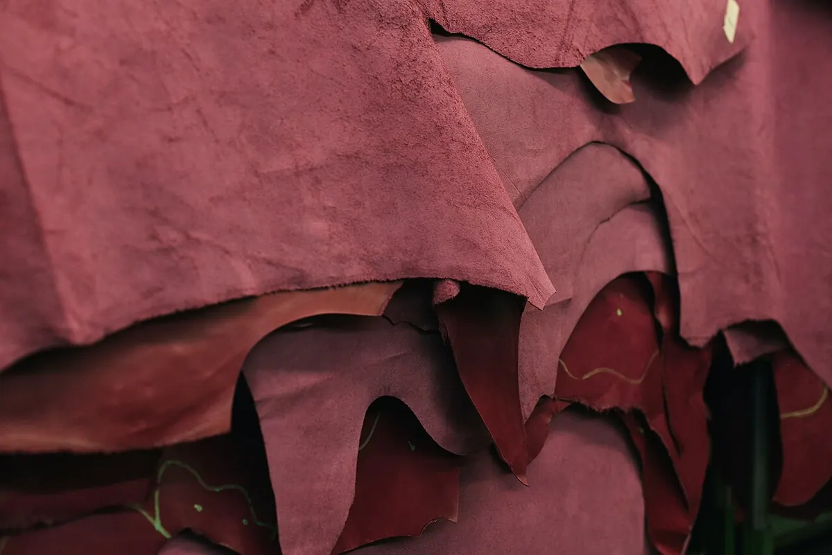 Stack of dyed magenta leather hides