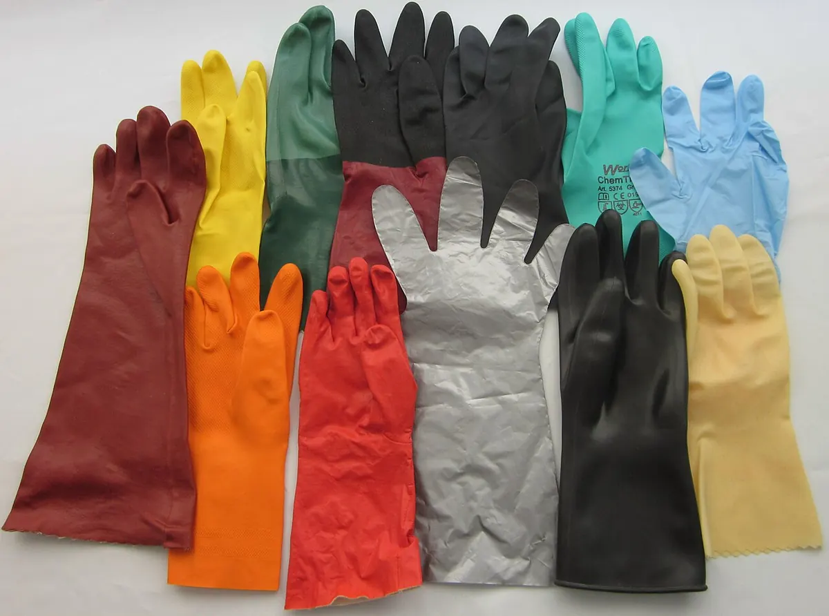 Rubber and nitrile protective gloves in many colours laid flat