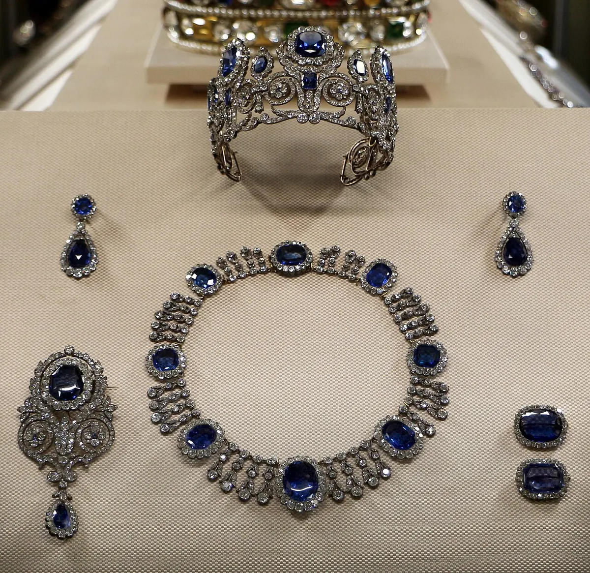 Sapphire and diamond tiara, necklace and earrings in a display case