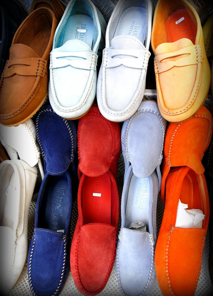 Rows of coloured suede loafers and moccasins