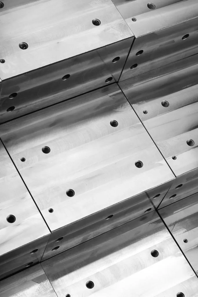 Stacked machined metal blocks with drilled and threaded holes