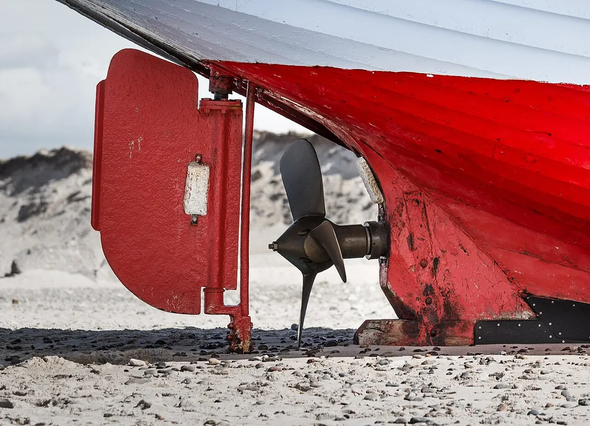 Rudder and propeller of a fishing vessel on a beach
