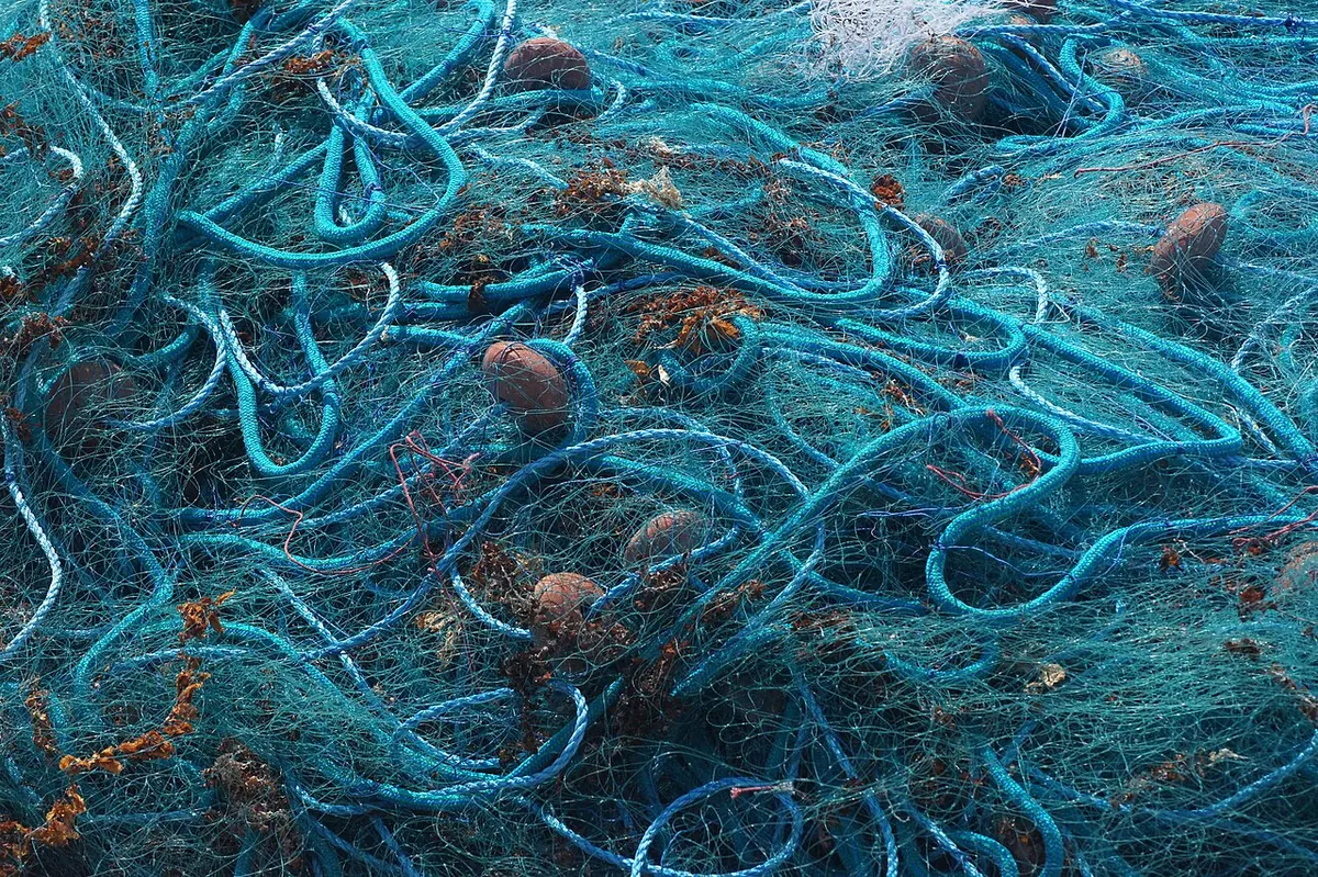 Pile of teal fishing net and blue rope