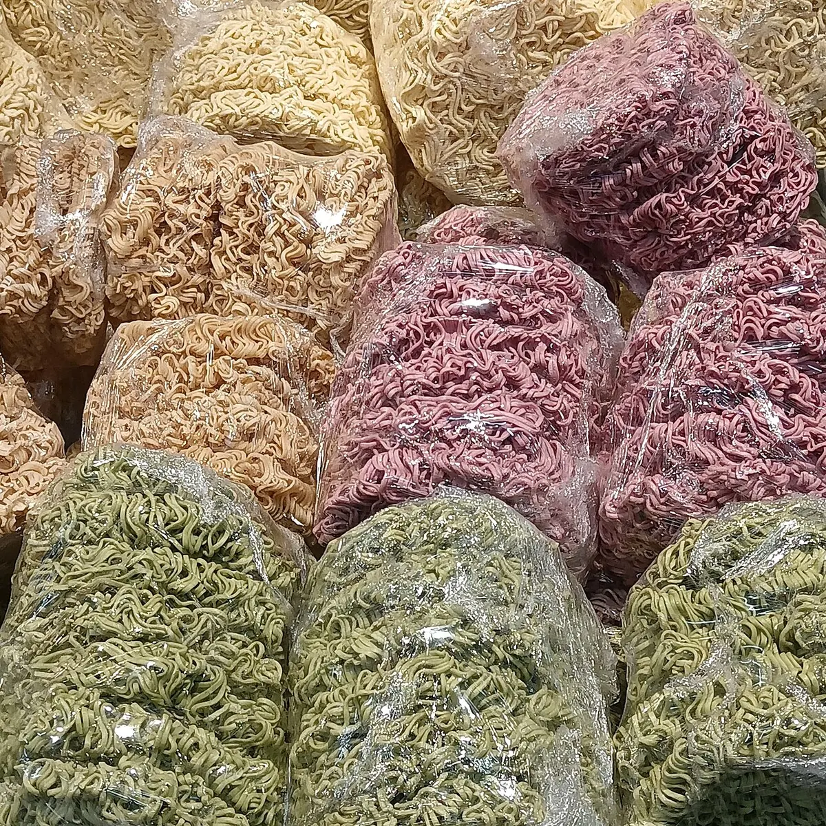 Coloured instant noodle blocks in clear wrappers