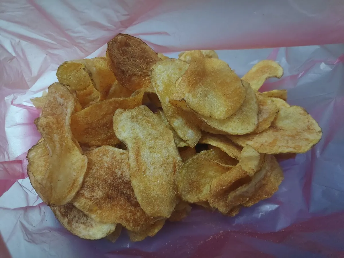 Seasoned potato chips on a pink plastic bag