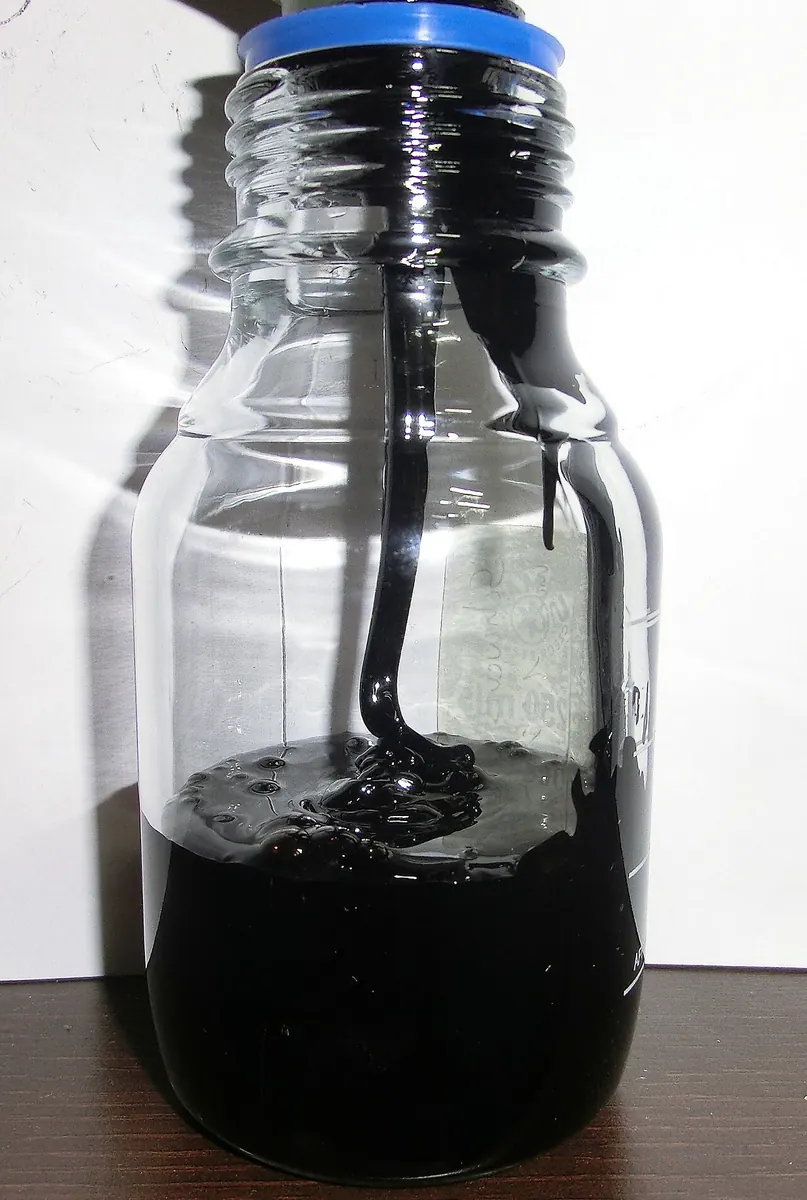Glass bottle of thick black residual fuel oil
