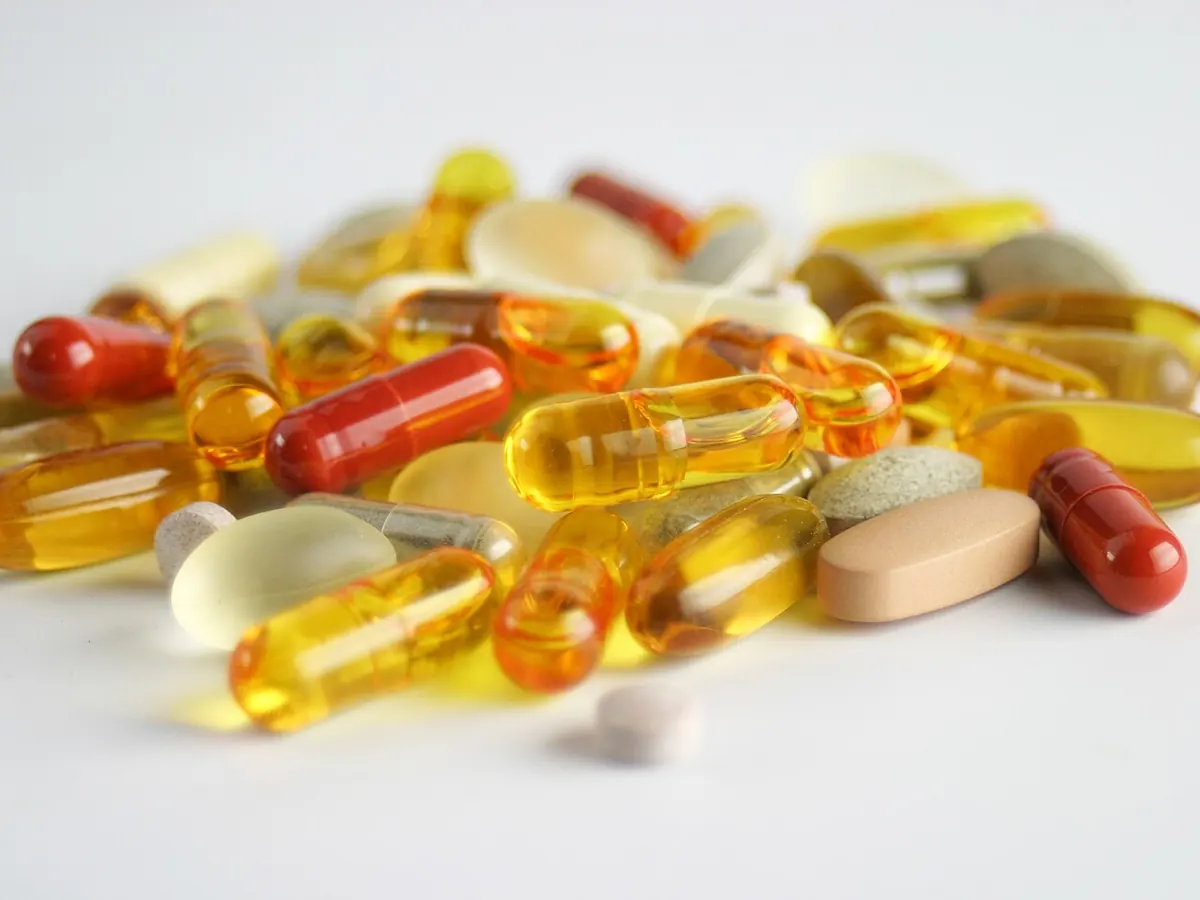 Assorted capsules, softgels and tablets on a white surface