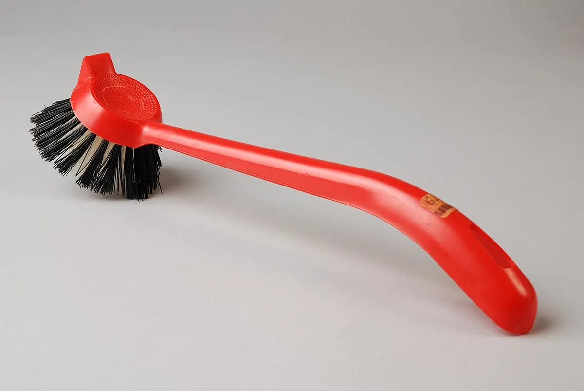 Red plastic dish brush with black and white bristles