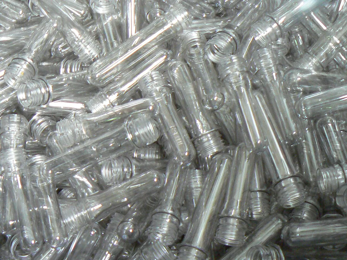 Heap of clear PET bottle preforms before blow moulding