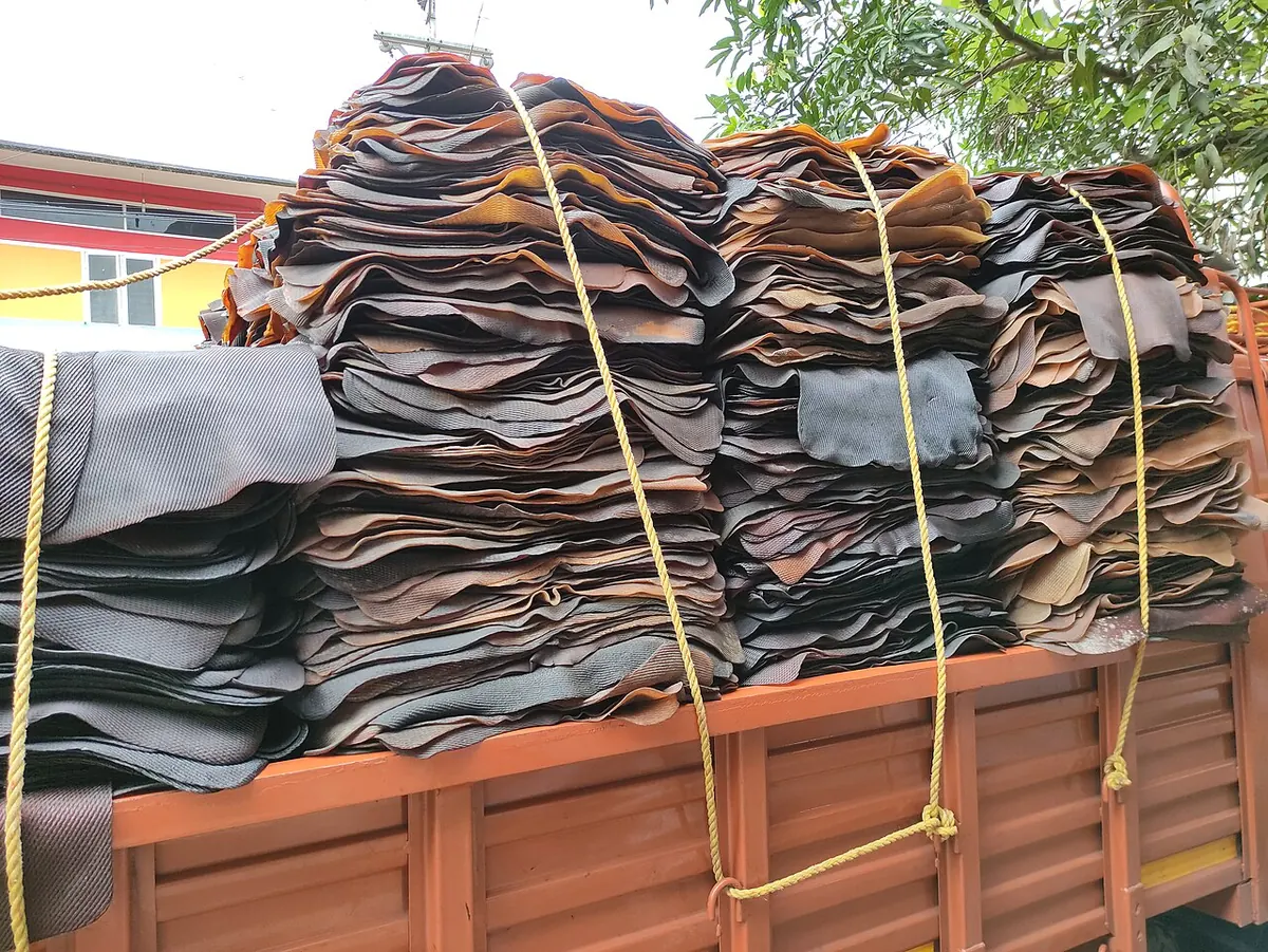 Stacks of brown ribbed smoked rubber sheets tied on a truck