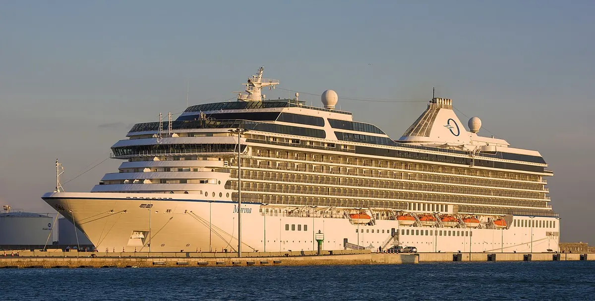 Large white passenger cruise ship moored at a quay