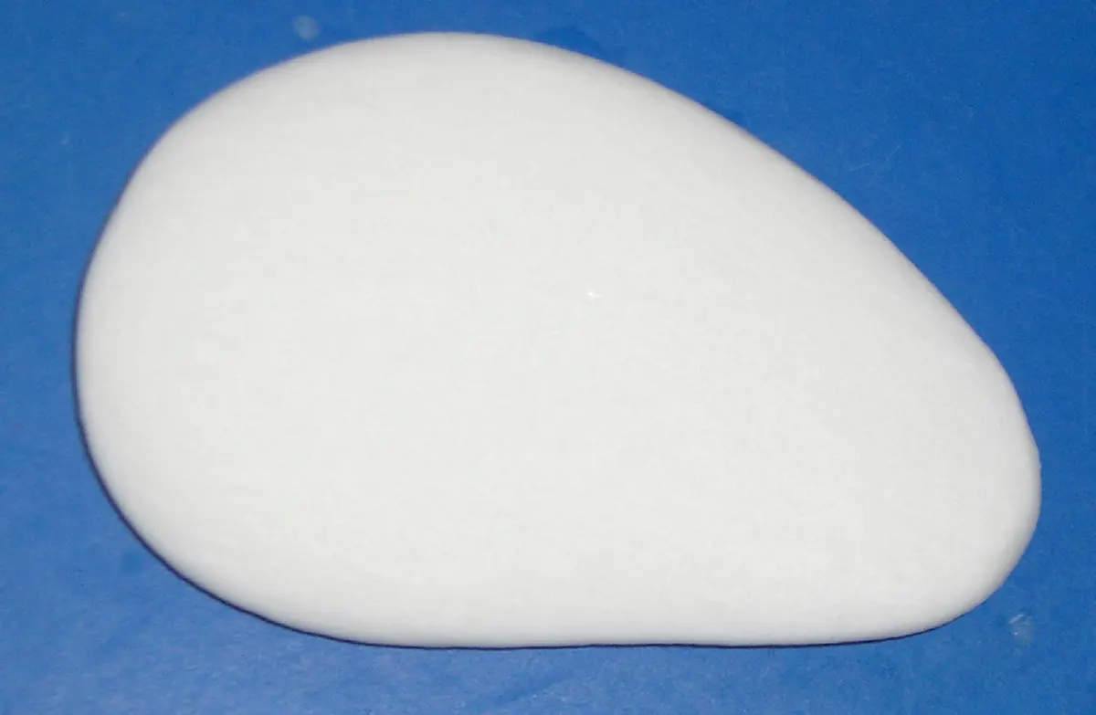 Plain white bar of soap on a blue background