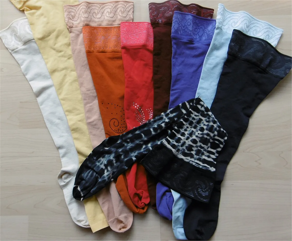 Medical compression stockings in many colours laid flat