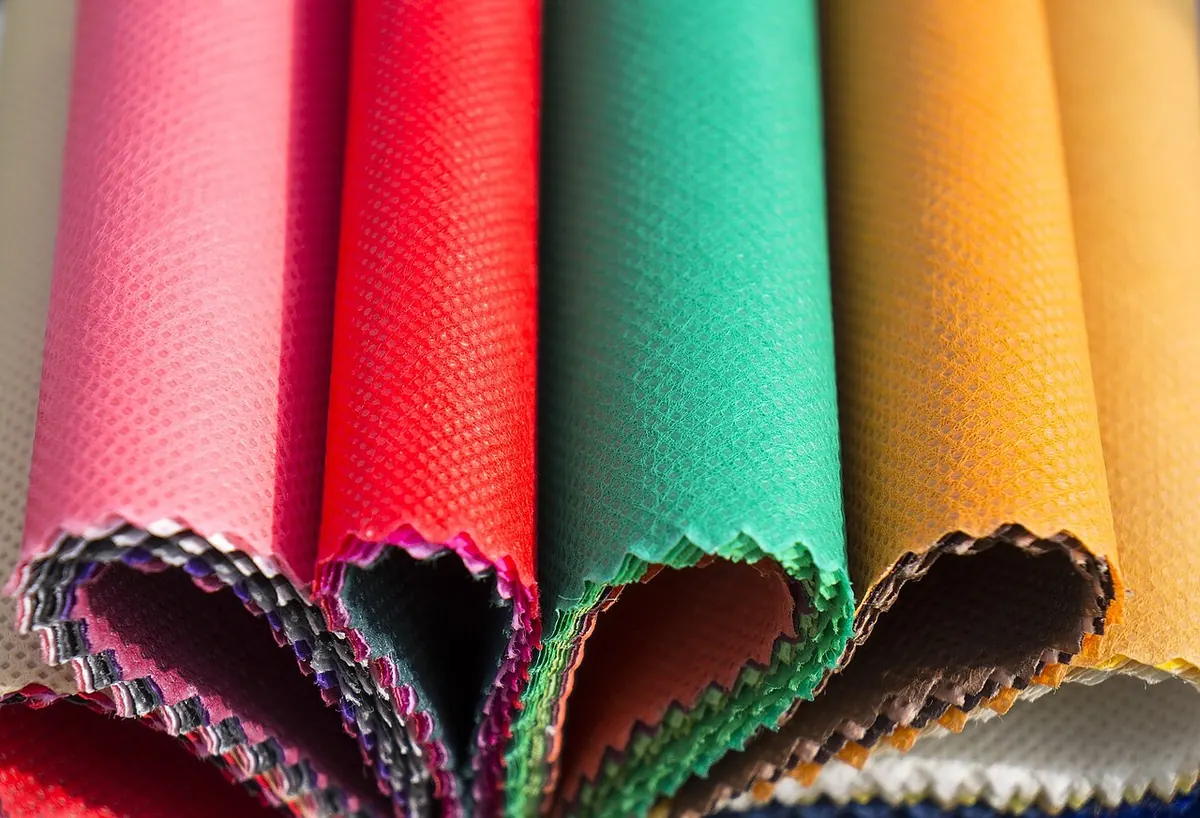 Fanned swatches of coloured nonwoven fabric