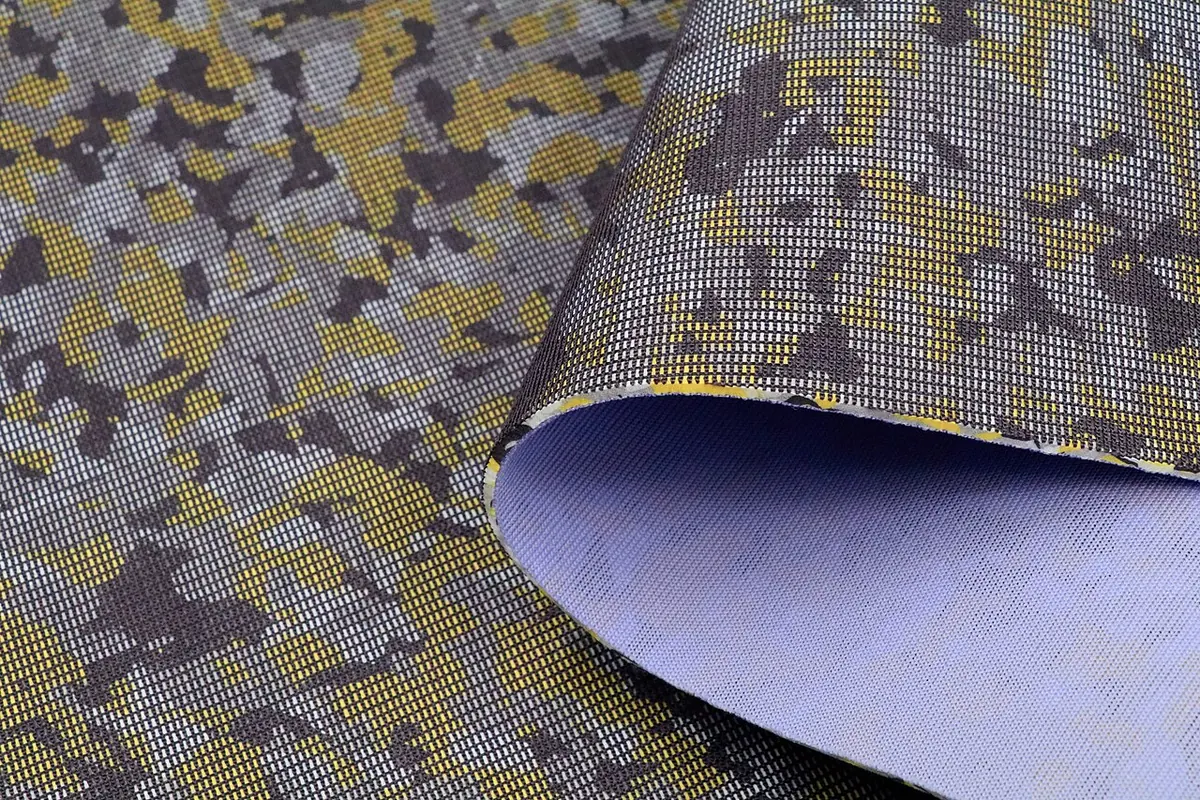 Camouflage fabric laminated to a lilac foam backing
