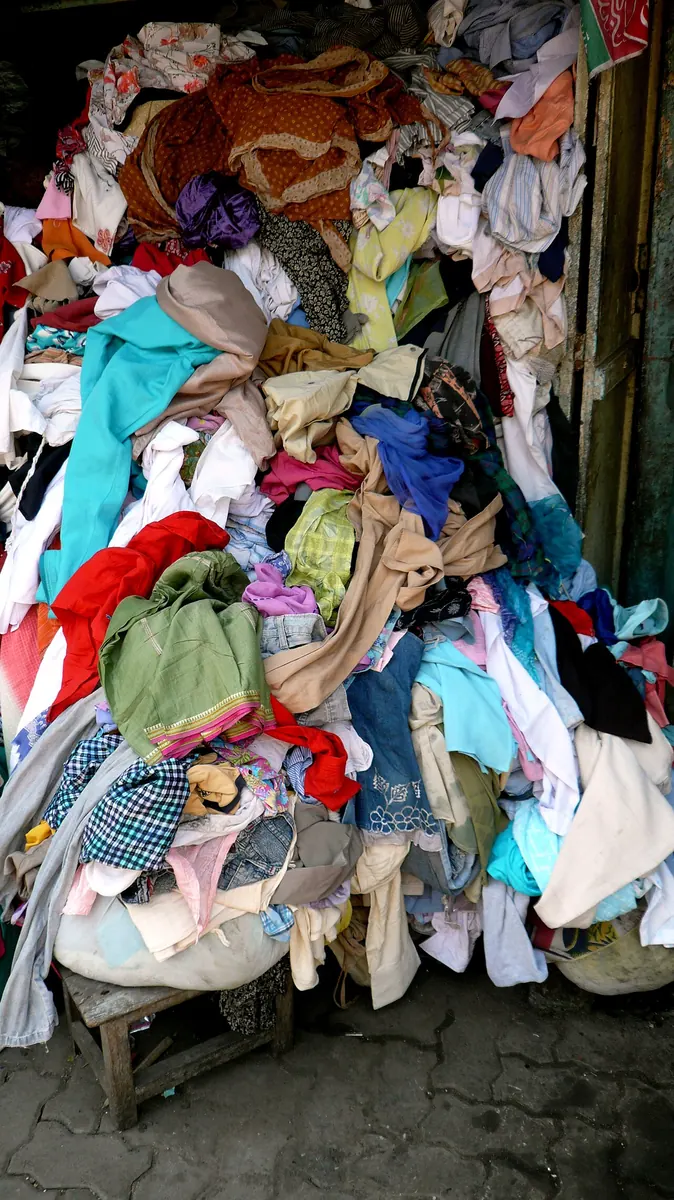 Heap of old clothes and rags at a market stall