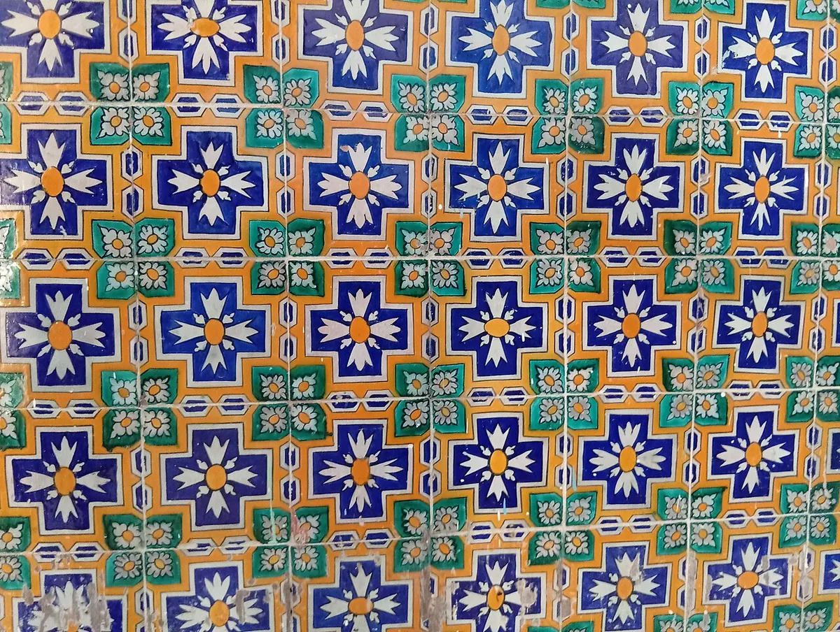 Wall of blue, green and orange patterned ceramic tiles