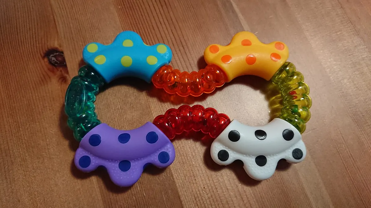 Colourful plastic baby rattle with beads inside