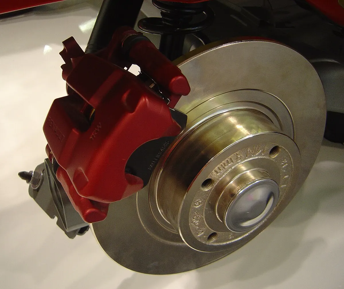 Car disc brake with a red caliper on display