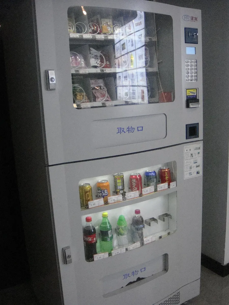 Snack and drink vending machine with a glass front