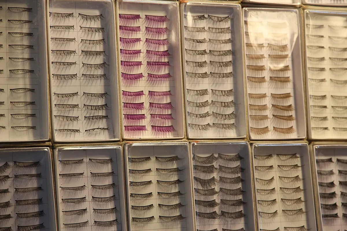 Rows of false eyelash strips in white display trays