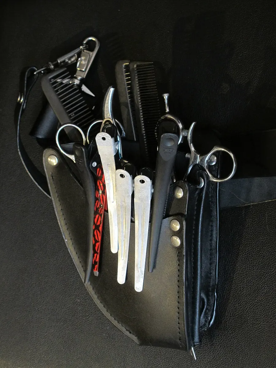 Combs, clips and scissors in a leather hairdresser's pouch