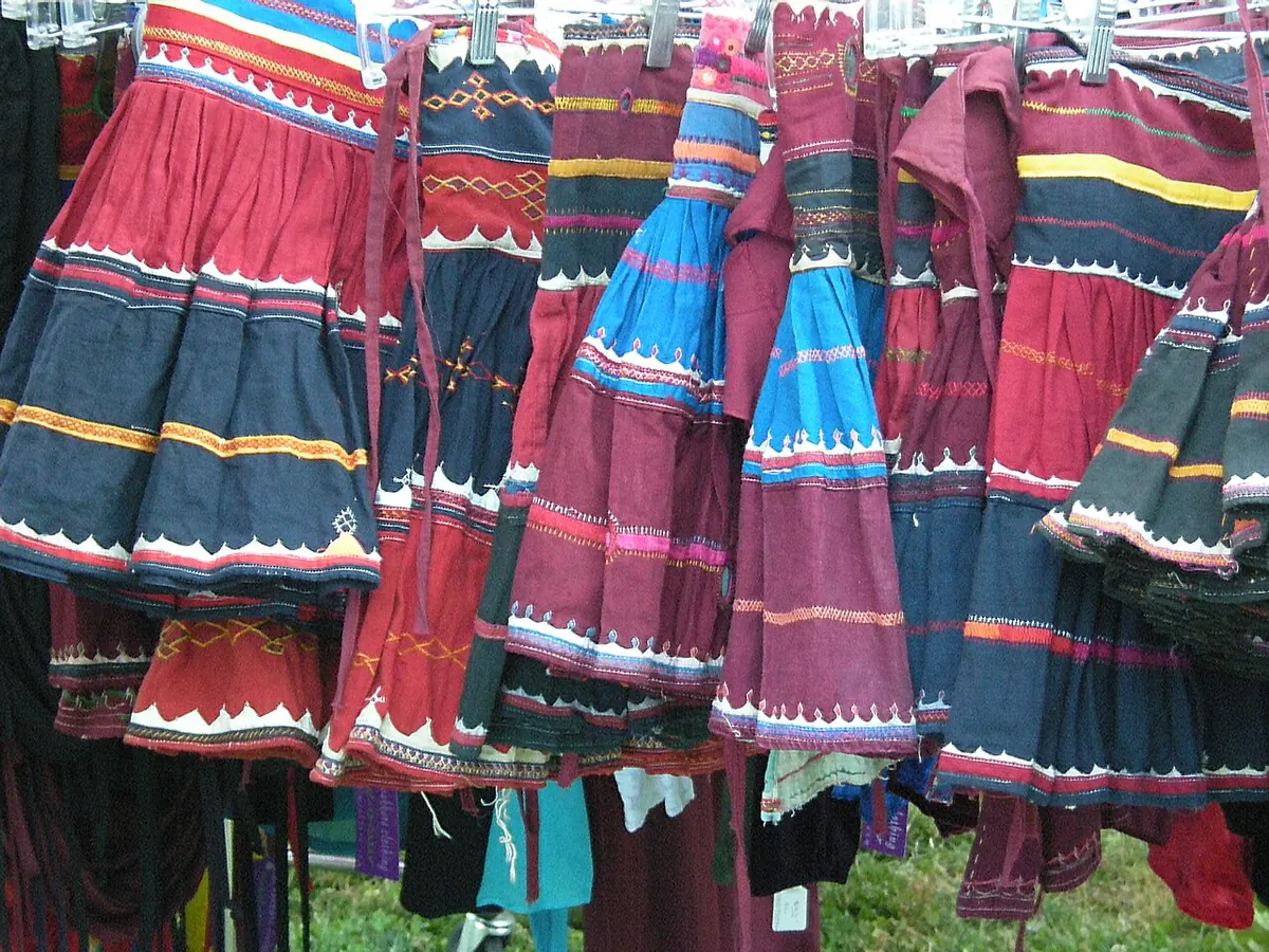 Colourful patchwork skirts hanging on a market rack