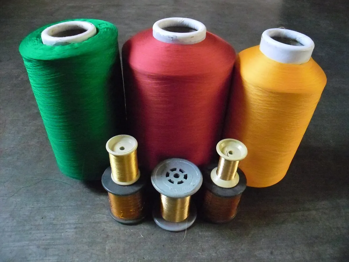 Polyester yarn cones in green, red and yellow